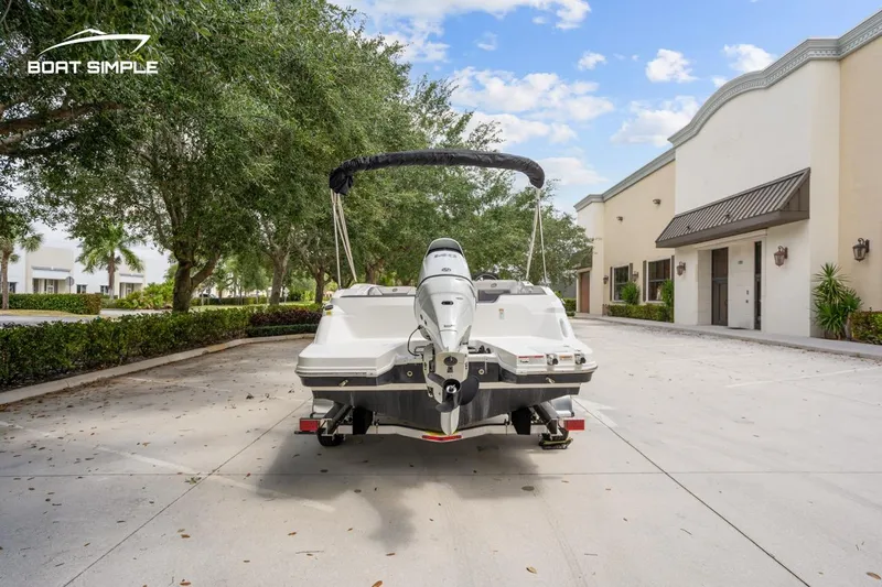 Slide: The Image of 2021 Hurricane SunDeck Sport 205 OB boat on trailer, parked in a sunny driveway. - 3