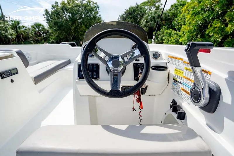 Slide: The Image of 2021 Hurricane SunDeck Sport 205 OB boat cockpit with steering wheel and control panel. - 5