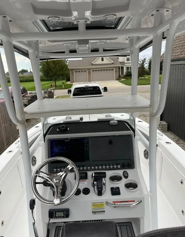 Slide: The Image of 2020 Crevalle 26 HBW boat console with steering wheel and navigation controls. - 10