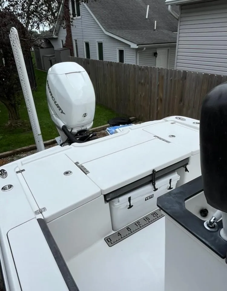 Slide: The Image of 2020 Crevalle 26 HBW boat with outboard motor, docked in residential backyard. - 18