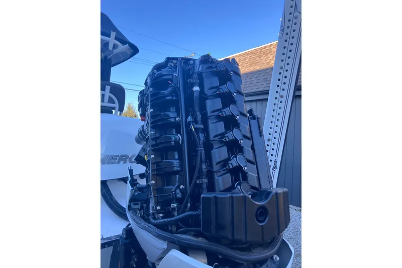 Slide: The Image of 2020 Crevalle 26 HBW boat engine close-up under blue sky. - 22