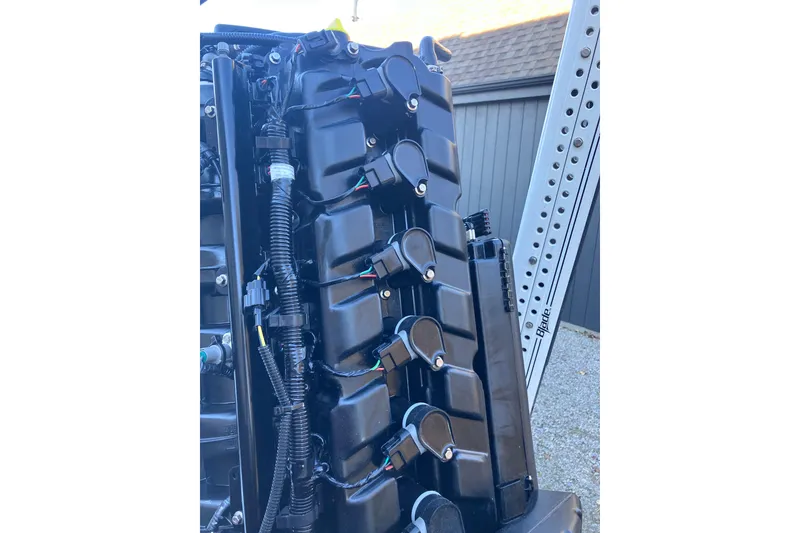 Slide: The Image of Close-up of a 2020 Crevalle 26 HBW boat engine, showcasing intricate wiring and components. - 28