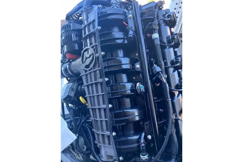 Slide: The Image of Close-up of a 2020 Crevalle 26 HBW boat engine, showcasing intricate mechanical details. - 31