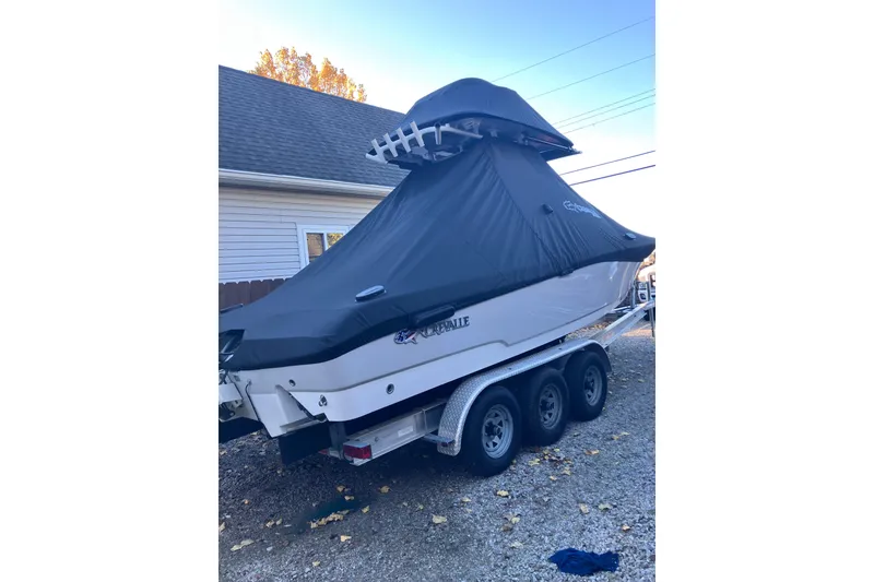 Slide: The Image of 2020 Crevalle 26 HBW boat covered on a trailer, parked outdoors. - 35