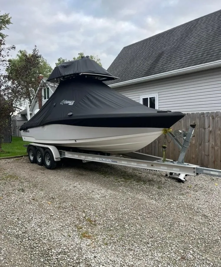Slide: The Image of 2020 Crevalle 26 HBW boat on trailer, covered, parked in residential driveway. - 6