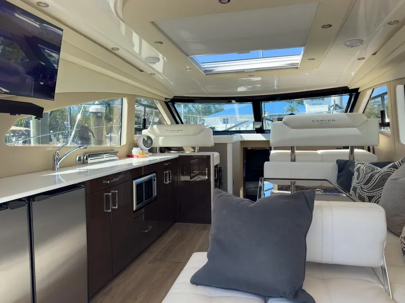 Slide: The Image of Luxurious interior of a 2019 Carver C43 Coupe yacht with modern amenities and seating. - 14