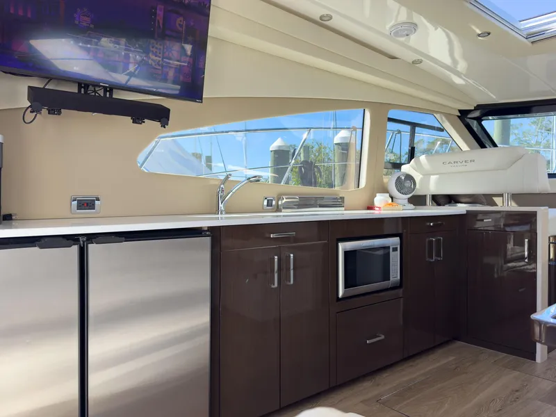 Slide: The Image of Interior of a 2019 Carver C43 Coupe yacht with modern kitchen amenities. - 17