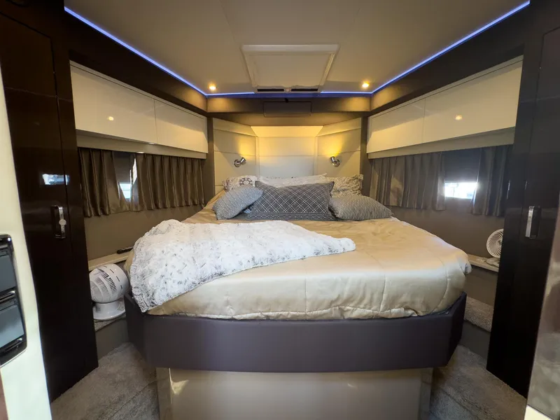 Slide: The Image of Luxurious bedroom interior in a 2019 Carver C43 Coupe yacht, featuring elegant bedding and ambient lighting. - 20