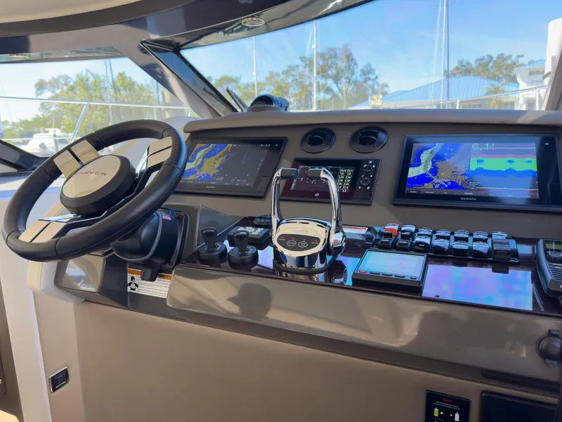 Slide: The Image of Modern boat cockpit with advanced navigation screens and controls, featuring a sleek steering wheel. - 24