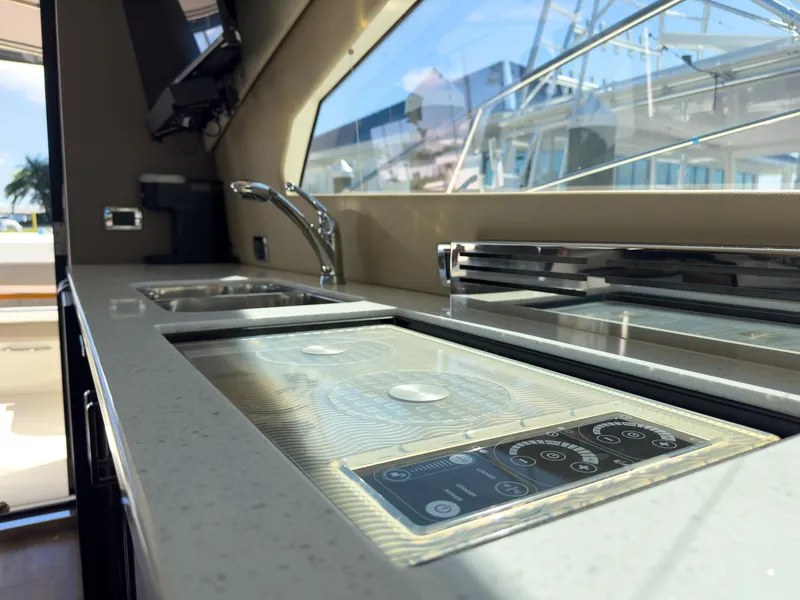 Slide: The Image of Luxurious kitchen interior of 2019 Carver C43 Coupe yacht with modern appliances. - 25