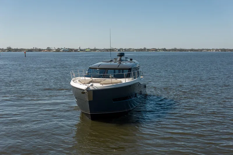 Slide: The Image of A 2019 Carver C43 Coupe yacht cruising on a calm, sunny day. - 4