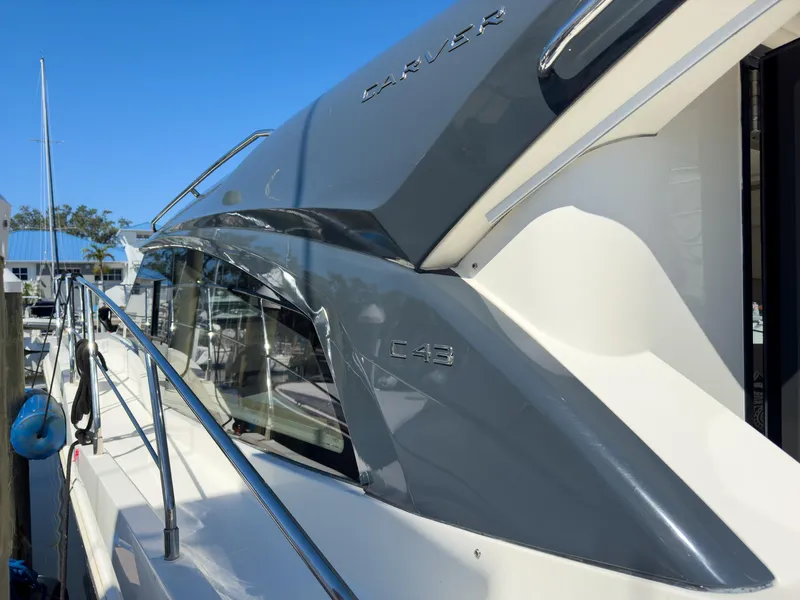 Slide: The Image of 2019 Carver C43 Coupe yacht docked, showcasing sleek design and modern features. - 8