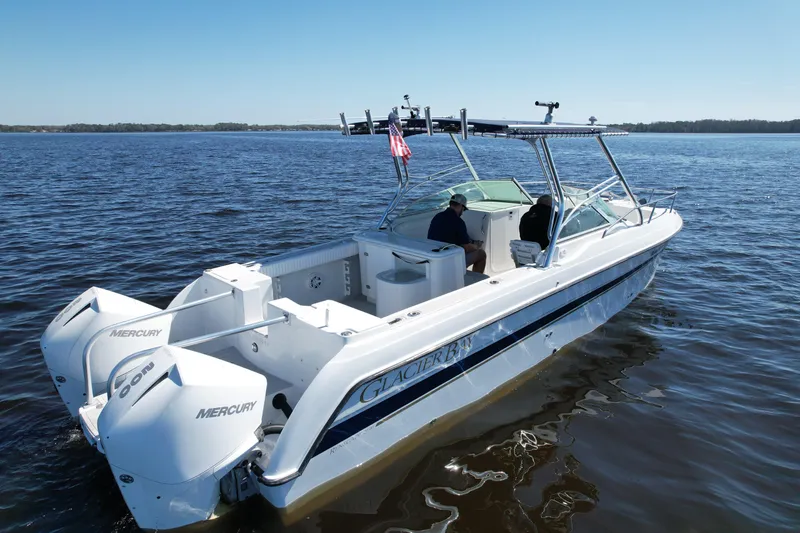 Slide: The Image of 2004 Glacier Bay Renegade 2640 boat on calm water with Mercury engines. - 10