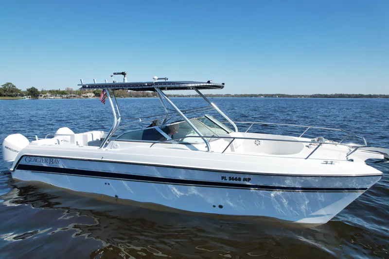 Slide: The Image of 2004 Glacier Bay Renegade 2640 boat on calm water under clear blue sky. - 12
