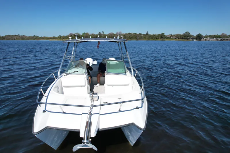 Slide: The Image of 2004 Glacier Bay Renegade 2640 boat on calm water under clear blue sky. - 14