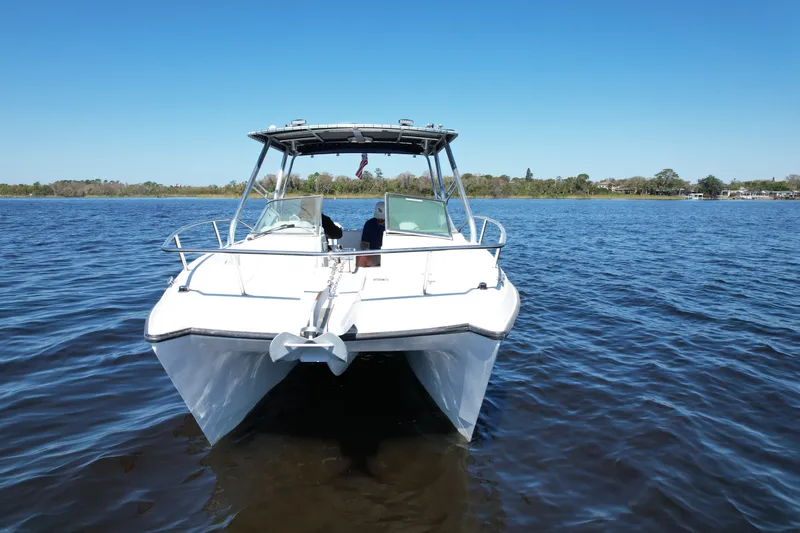 Slide: The Image of 2004 Glacier Bay Renegade 2640 catamaran on calm water under clear blue sky. - 15