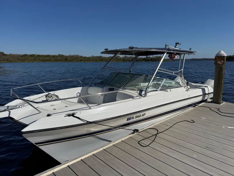 Slide: The Image of 2004 Glacier Bay Renegade 2640 boat docked on a sunny day. - 18