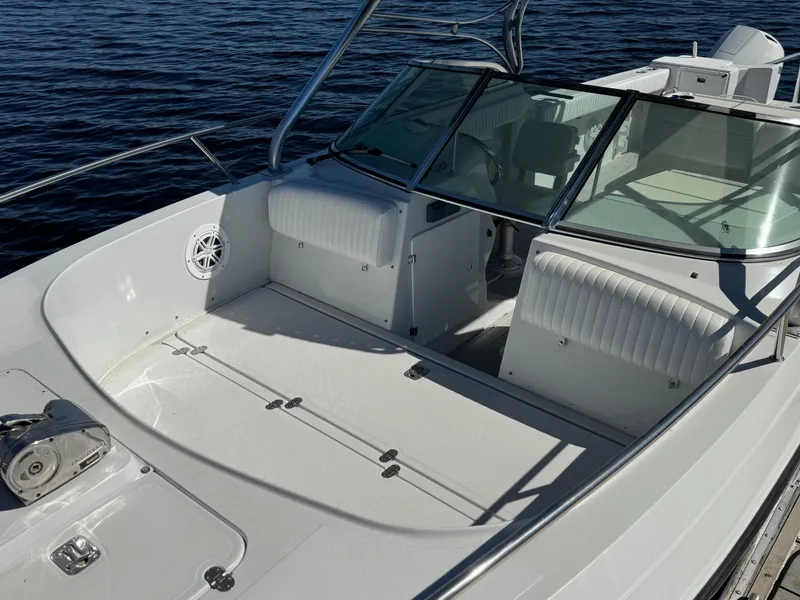 Slide: The Image of 2004 Glacier Bay Renegade 2640 boat with spacious deck and seating on calm water. - 20