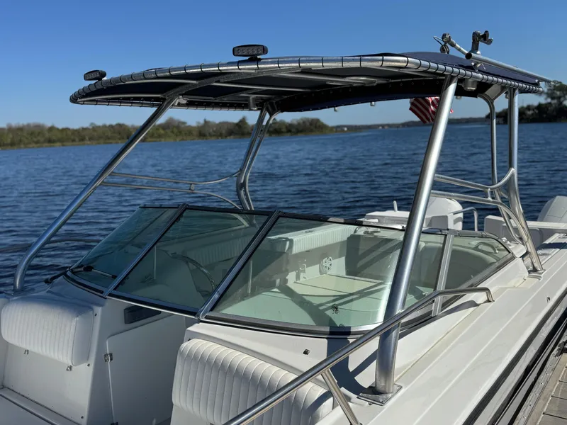Slide: The Image of 2004 Glacier Bay Renegade 2640 boat on calm water with clear blue sky. - 21