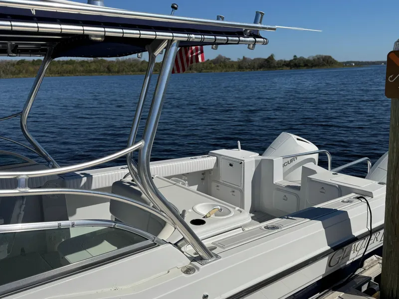Slide: The Image of 2004 Glacier Bay Renegade 2640 boat docked by a serene lake. - 22