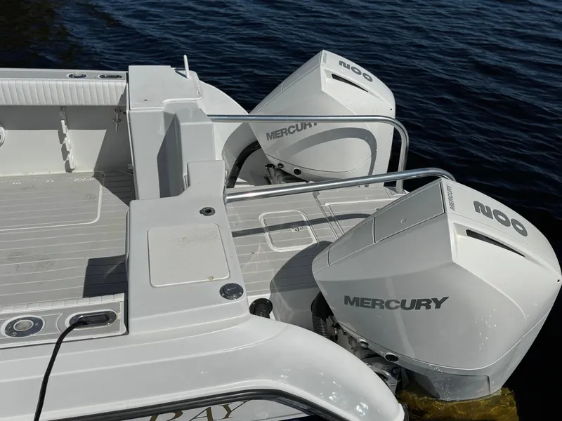 Slide: The Image of 2004 Glacier Bay Renegade 2640 boat with dual Mercury outboard engines on water. - 23