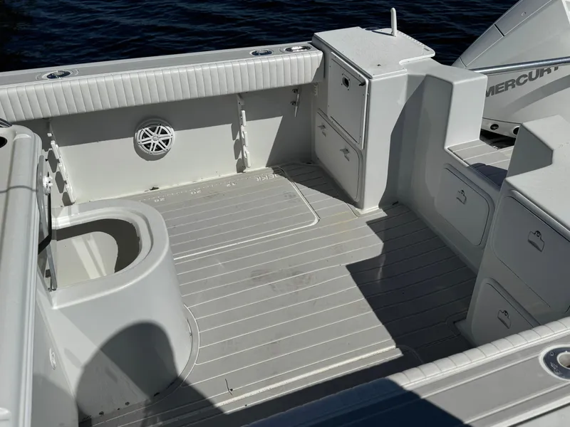 Slide: The Image of 2004 Glacier Bay Renegade 2640 boat interior with storage compartments and seating. - 24