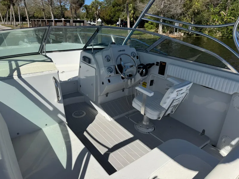 Slide: The Image of 2004 Glacier Bay Renegade 2640 boat interior with steering wheel and seating. - 29