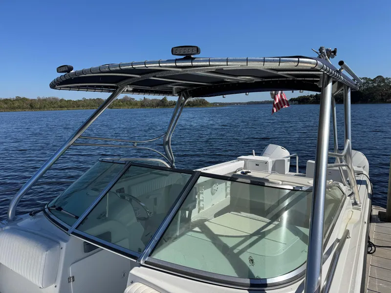 Slide: The Image of 2004 Glacier Bay Renegade 2640 boat docked on a sunny day. - 32