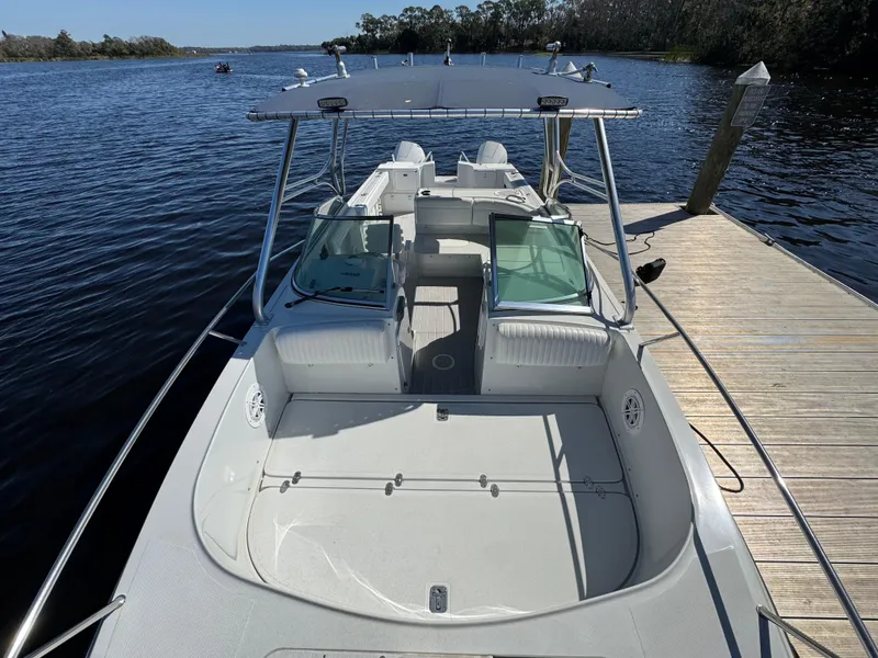 Slide: The Image of 2004 Glacier Bay Renegade 2640 boat docked on a serene lake. - 34