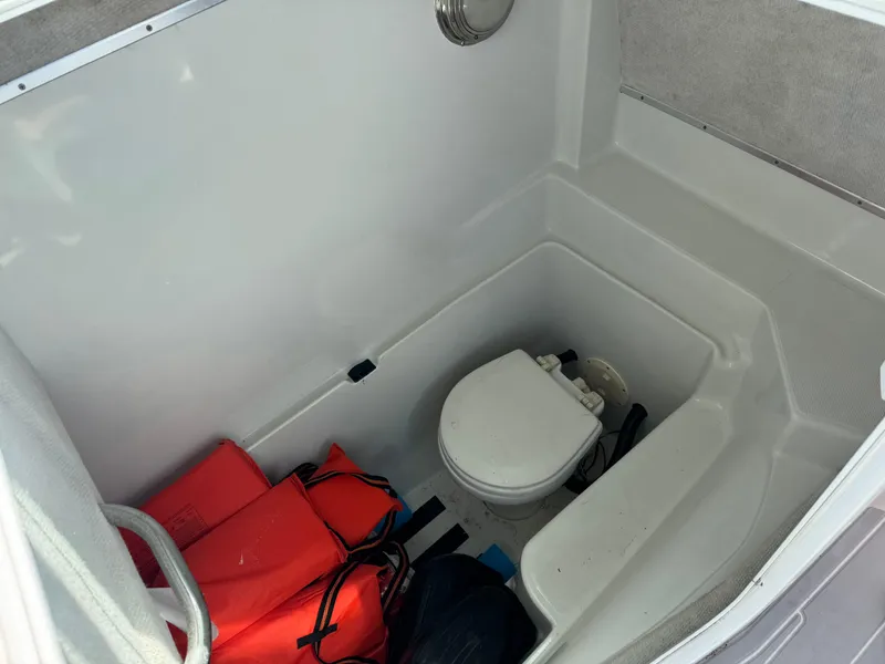 Slide: The Image of 2004 Glacier Bay Renegade 2640 boat interior with toilet and life jackets. - 38