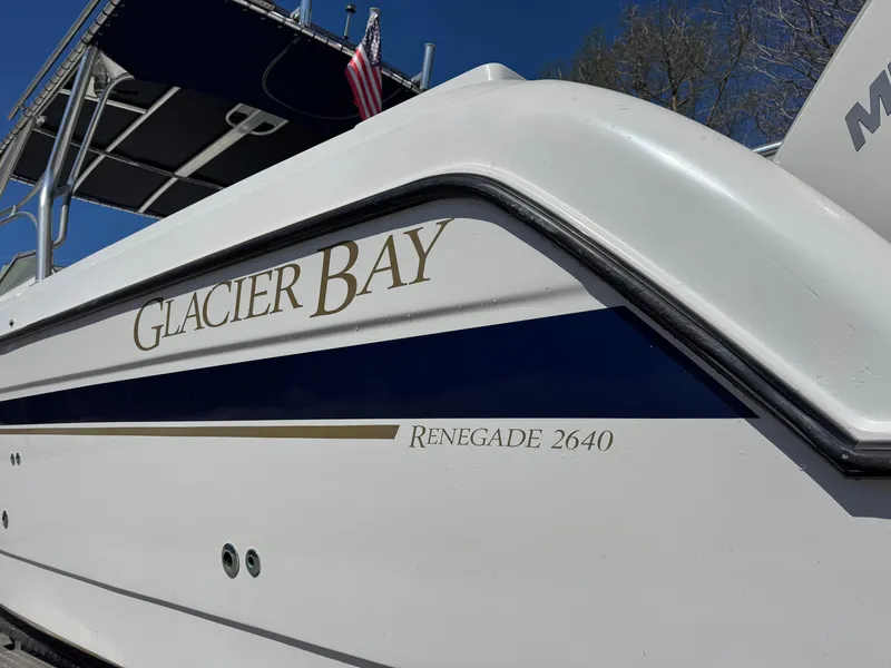 Slide: The Image of 2004 Glacier Bay Renegade 2640 boat with American flag, side view. - 39