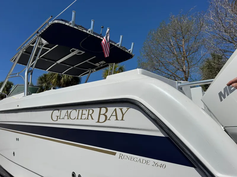 Slide: The Image of 2004 Glacier Bay Renegade 2640 boat with canopy and American flag. - 40
