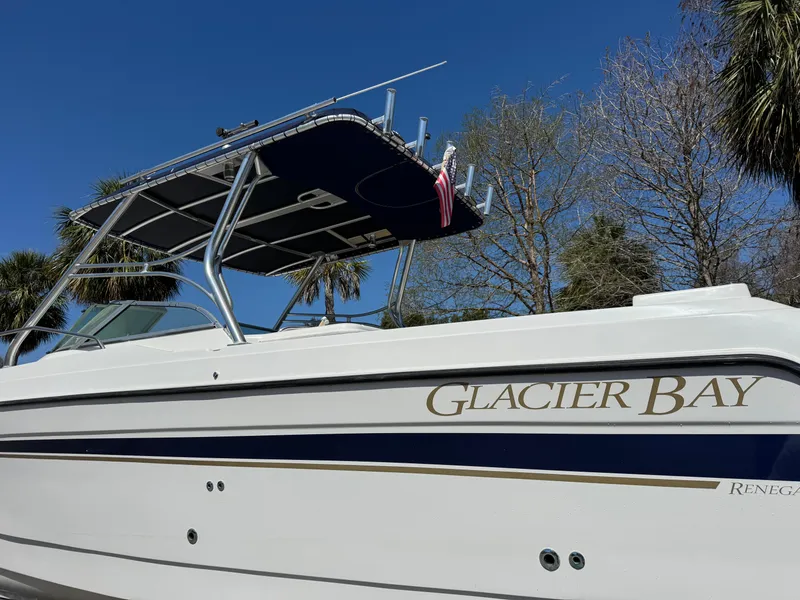 Slide: The Image of 2004 Glacier Bay Renegade 2640 boat with canopy against a clear blue sky. - 41
