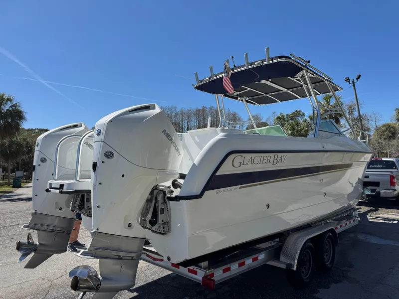 Slide: The Image of 2004 Glacier Bay Renegade 2640 boat on trailer, dual engines, sunny day. - 43