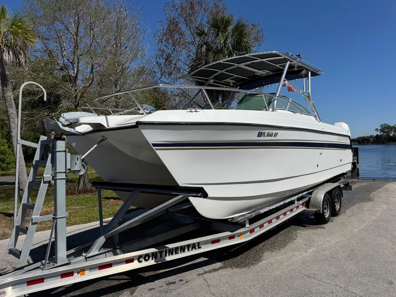 Slide: The Image of 2004 Glacier Bay Renegade 2640 boat on trailer by lakeside. - 48