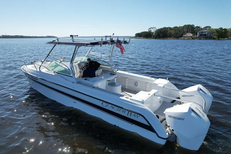 Slide: The Image of 2004 Glacier Bay Renegade 2640 boat on calm water with twin Mercury engines. - 6