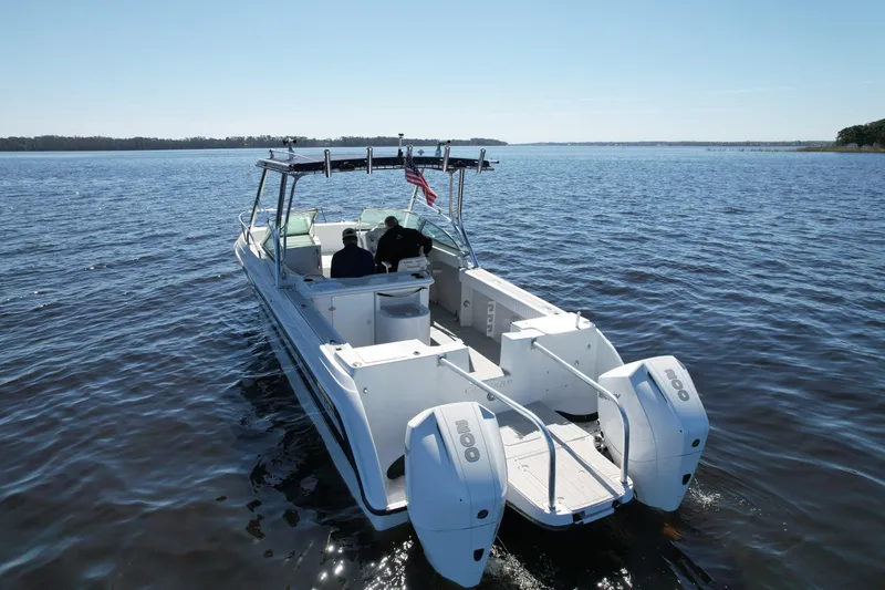 Slide: The Image of 2004 Glacier Bay Renegade 2640 boat cruising on open water. - 7