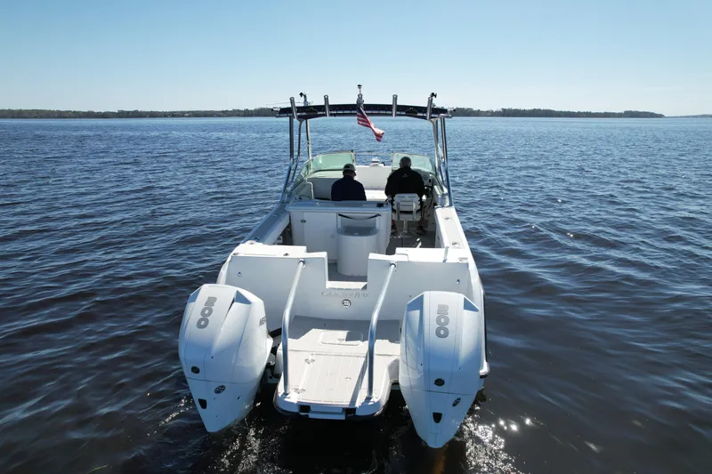 Slide: The Image of 2004 Glacier Bay Renegade 2640 boat cruising on open water, rear view. - 9