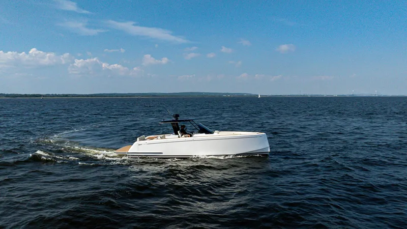 The Image of 2025 Pardo Yachts 38 Walkaround cruising on open water under a clear blue sky. - 0