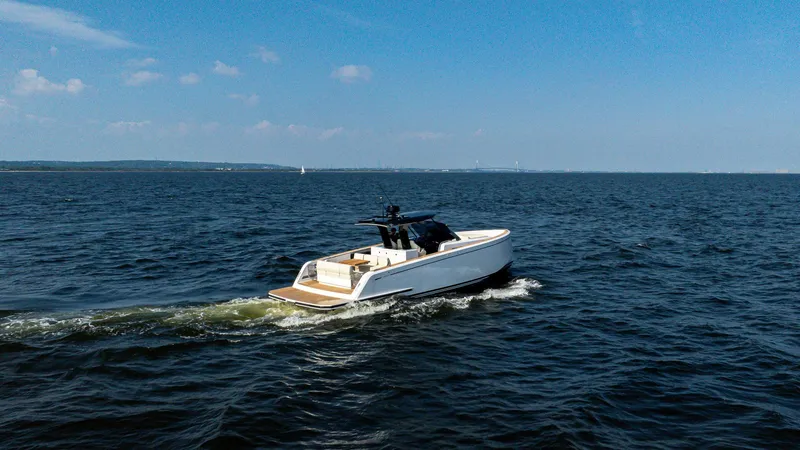 The Image of 2025 Pardo Yachts 38 Walkaround cruising on open water under clear skies. - 1