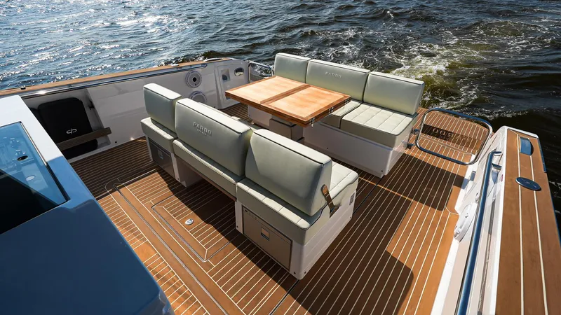 Slide: The Image of 2025 Pardo Yachts 38 Walkaround deck with seating and table on the water. - 14