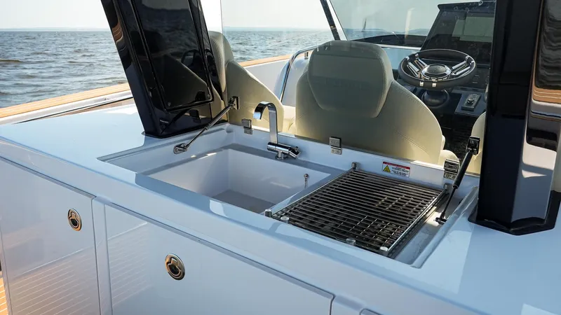Slide: The Image of 2025 Pardo Yachts 38 Walkaround, featuring a sleek outdoor sink and grill setup. - 16