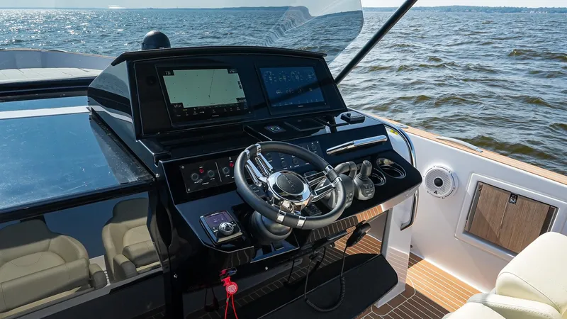 Slide: The Image of 2025 Pardo Yachts 38 Walkaround helm with modern navigation system on open water. - 21