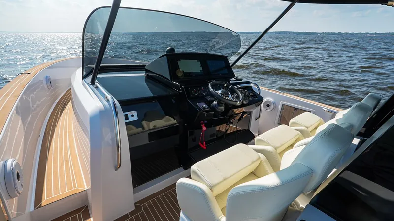 Slide: The Image of 2025 Pardo Yachts 38 Walkaround cockpit with luxurious seating and modern controls on open water. - 23