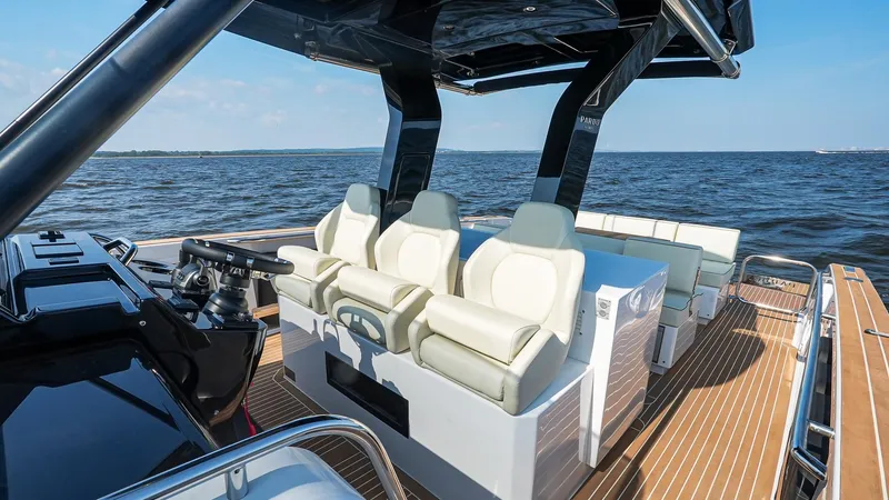 Slide: The Image of 2025 Pardo Yachts 38 Walkaround, luxurious seating, sleek design, cruising on open water. - 24
