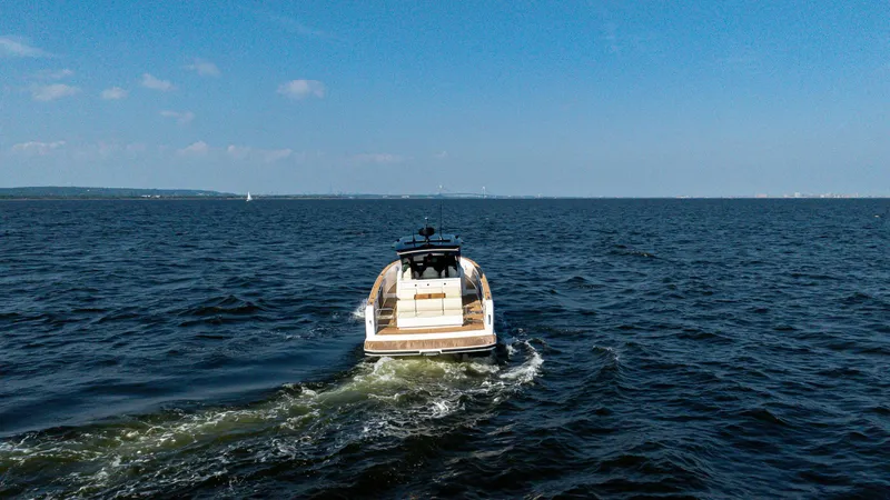 Slide: The Image of 2025 Pardo Yachts 38 Walkaround cruising on open water under clear blue skies. - 4