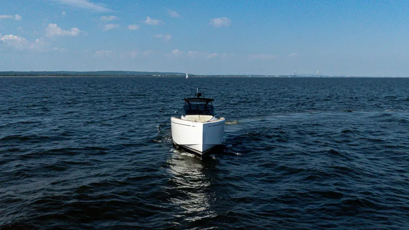 Slide: The Image of 2025 Pardo Yachts 38 Walkaround cruising on open water under a clear blue sky. - 5