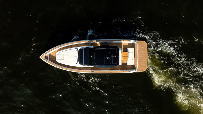 Slide: The Image of 2025 Pardo Yachts 38 Walkaround cruising on dark water, aerial view. - 8