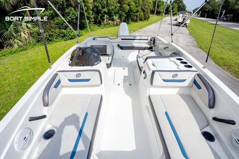 Slide: The Image of 2021 Hurricane SunDeck Sport 205 OB boat interior with seating and console, parked on grass. - 4