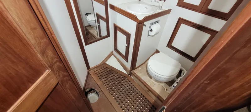Slide: The Image of 1980 Shannon 38 Ketch bathroom with wooden accents and compact design. - 10